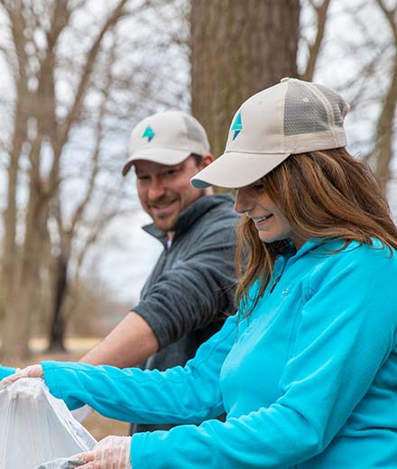 Taylor Bank employees pick up debris at a local park.
