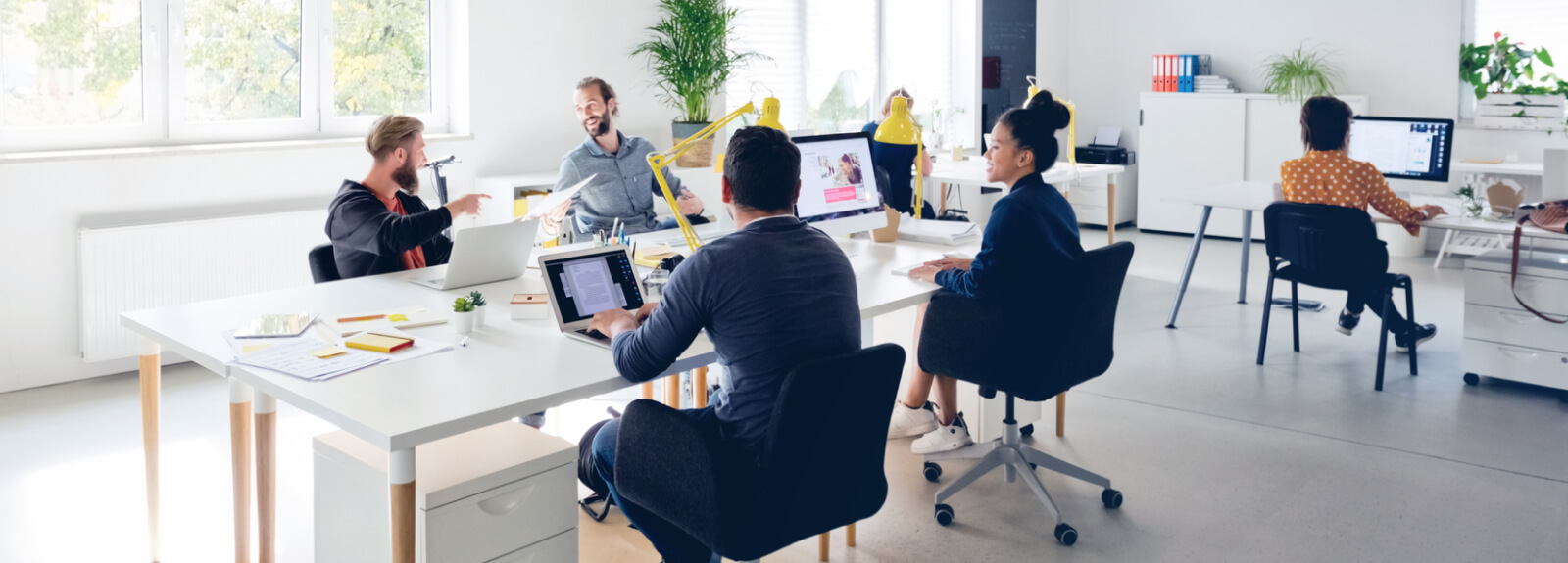 Wide shot of several people in an office