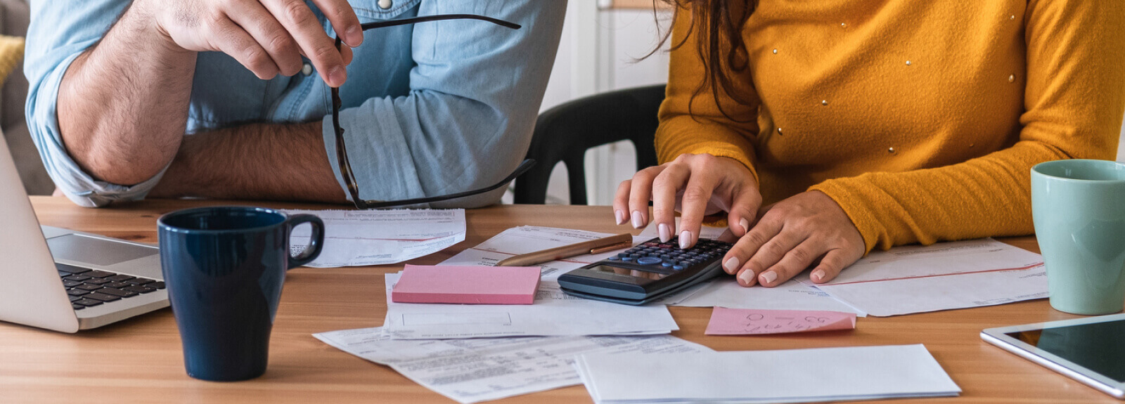 Two people with documents and a calculator