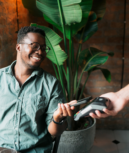 Man using a smartphone to complete a payment through a digital wallet application.