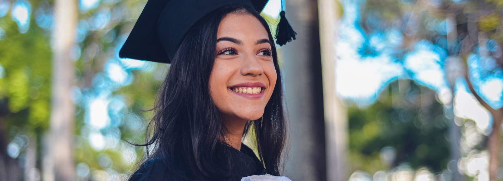 A young woman wearing a graduation cap