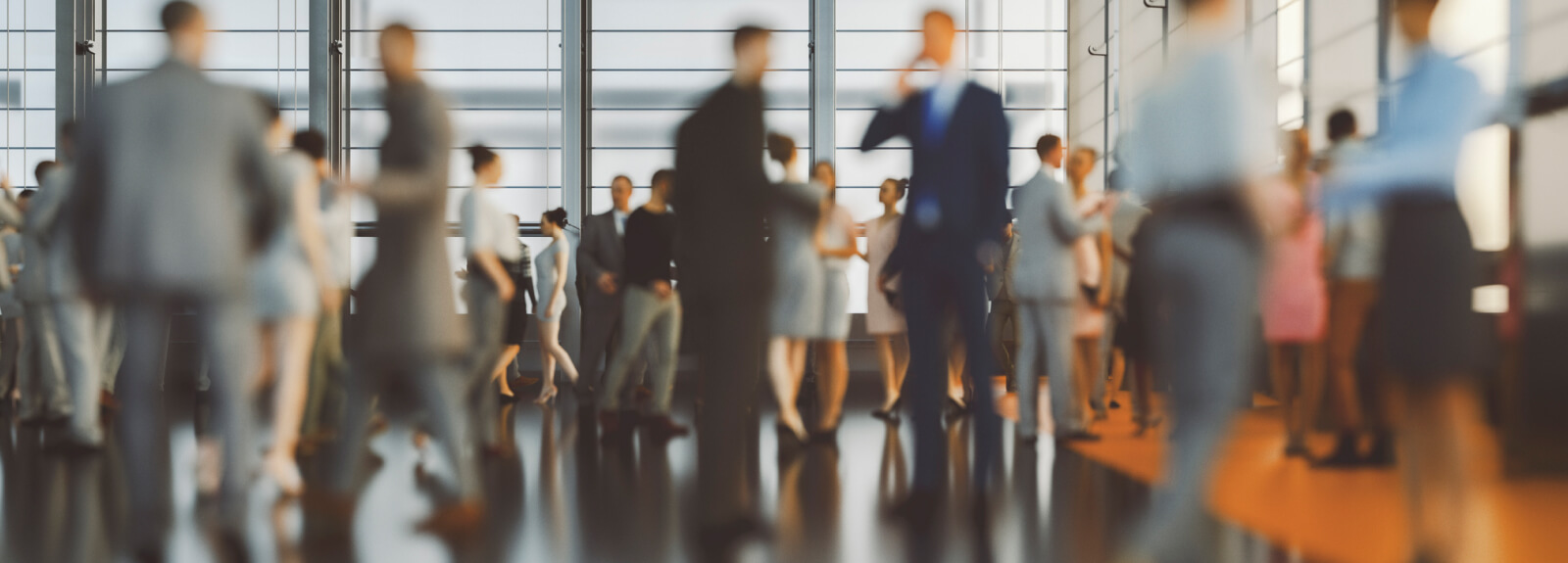 Wide shot of many business people working around an office